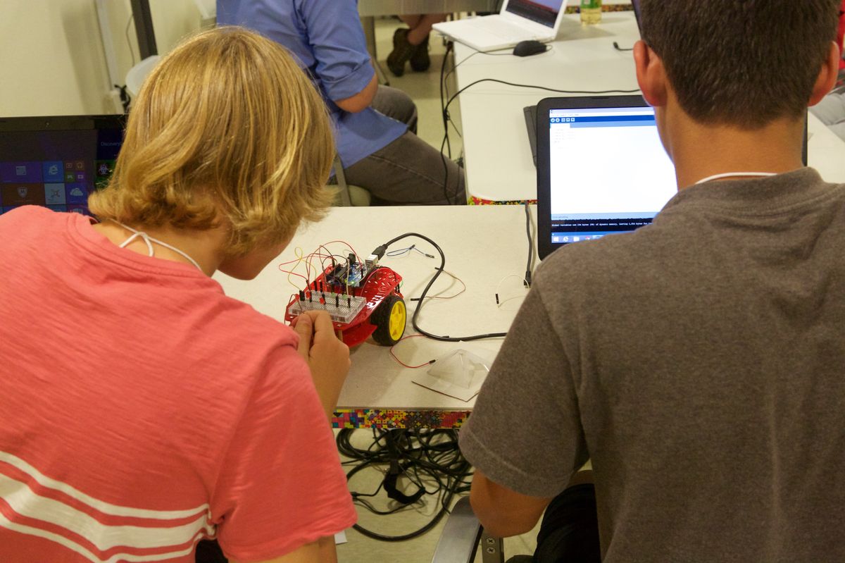 A student wiring an Arduino robot car