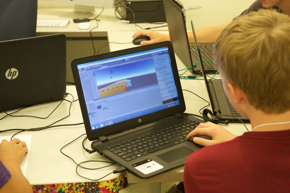 A student programming a 3D video game